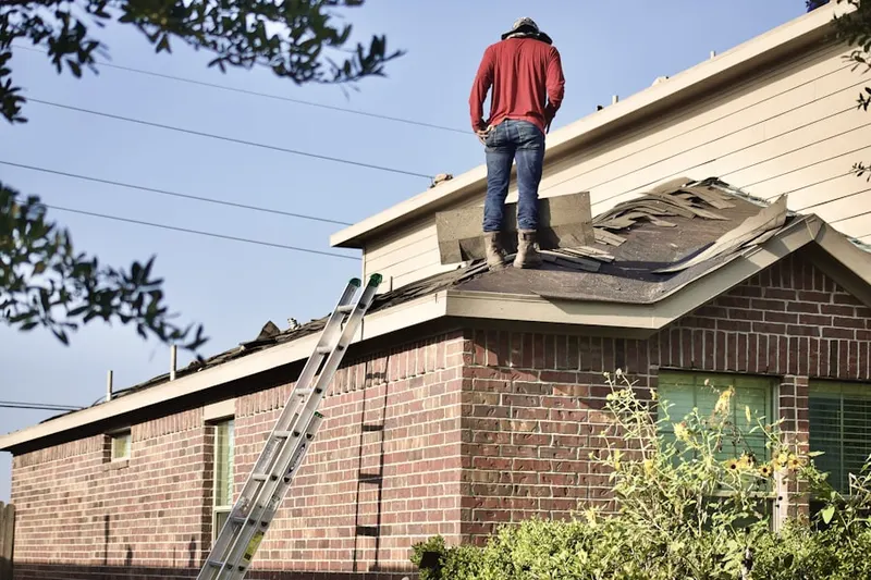 Professional roofer working on a residential roof in Wheeling